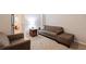 The well-lit living room features a comfortable sofa set, a side table with a lamp, and neutral decor at 2690 Valvedere Dr, Brookhaven, GA 30319