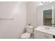 The powder room features a large mirror, single vanity, and neutral wall color at 2690 Valvedere Dr, Brookhaven, GA 30319