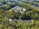 Stunning aerial shot of community amenities including pool, tennis courts, and clubhouse surrounded by mature trees at 6350 Bridge Brook Ovlk, Cumming, GA 30028