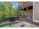 Backyard with multiple decks, lush green trees, black fence and stone pavers at 6350 Bridge Brook Ovlk, Cumming, GA 30028