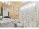 Full bathroom with a single sink vanity, tiled walls, and a shower at 6350 Bridge Brook Ovlk, Cumming, GA 30028