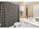 Bathroom featuring shower with black and white shower curtain and large vanity at 6350 Bridge Brook Ovlk, Cumming, GA 30028