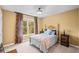 Bedroom with a large window, carpeted floors, and light yellow walls. and side tables at 6350 Bridge Brook Ovlk, Cumming, GA 30028