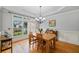 Bright dining room with hardwood floors, large window, and tray ceiling at 6350 Bridge Brook Ovlk, Cumming, GA 30028