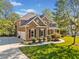 Well-manicured lawn, stone accents, two story home with a charming covered porch at 6350 Bridge Brook Ovlk, Cumming, GA 30028