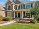 Charming home featuring a covered porch, stone accents, and a welcoming entrance at 6350 Bridge Brook Ovlk, Cumming, GA 30028
