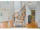 Elegant foyer with hardwood floors, staircase with iron railings, and natural light at 6350 Bridge Brook Ovlk, Cumming, GA 30028