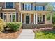 Charming home featuring a covered porch, stone accents, and a welcoming entrance at 6350 Bridge Brook Ovlk, Cumming, GA 30028