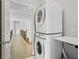 Upstairs laundry room with stacked washer and dryer at 6350 Bridge Brook Ovlk, Cumming, GA 30028