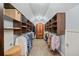 Large walk-in closet with custom shelving and ample storage space for clothes and accessories at 6350 Bridge Brook Ovlk, Cumming, GA 30028