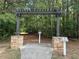 Picturesque entrance to a peaceful walking trail with a pergola and stone accents at 6350 Bridge Brook Ovlk, Cumming, GA 30028