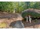 Scenic view of a walking trail through a wooded area, featuring trail markers and lush greenery at 6350 Bridge Brook Ovlk, Cumming, GA 30028