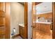Convenient bathroom with neutral colored walls right outside of the kitchen with wooden cabinets at 6575 Roundhill Ct, Cumming, GA 30040