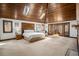 Spacious main bedroom featuring a vaulted wood ceiling, carpet, and access to the outdoors at 6575 Roundhill Ct, Cumming, GA 30040