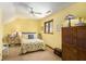 Cozy bedroom with ceiling fan, complemented by natural light, offers a comfortable retreat at 6575 Roundhill Ct, Cumming, GA 30040