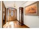 Elegant foyer featuring wood flooring, an antique clock and a beautiful wooden door at 6575 Roundhill Ct, Cumming, GA 30040