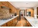Well-lit kitchen featuring ample counter space, wood cabinets and modern appliances at 6575 Roundhill Ct, Cumming, GA 30040