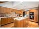 Spacious kitchen featuring wood cabinets, white countertops, and modern appliances at 6575 Roundhill Ct, Cumming, GA 30040