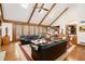 Inviting living room with hardwood floors, beamed ceilings, large windows, and comfortable seating at 6575 Roundhill Ct, Cumming, GA 30040