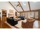 Inviting living room with vaulted ceilings, skylights, fireplace, and large windows at 6575 Roundhill Ct, Cumming, GA 30040