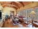 Bright living room with vaulted ceilings, rustic furniture, and abundant natural light at 6575 Roundhill Ct, Cumming, GA 30040