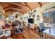 Relaxing living room with vaulted wood ceilings, rustic furniture, and abundant natural light at 6575 Roundhill Ct, Cumming, GA 30040