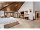 Large main bedroom featuring a fireplace, vaulted wood ceiling, and access to the outdoors at 6575 Roundhill Ct, Cumming, GA 30040