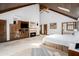 Spacious main bedroom featuring a fireplace, vaulted wood ceiling, and a sitting area at 6575 Roundhill Ct, Cumming, GA 30040