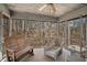 Comfortable screened porch with wooden bench and wicker furniture overlooking wooded area at 6575 Roundhill Ct, Cumming, GA 30040