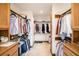 Organized walk-in closet with double hanging rods and built-in shelving for optimal storage at 6575 Roundhill Ct, Cumming, GA 30040
