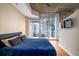 Comfortable bedroom with access to a private balcony offering city views at 855 Peachtree Ne St # 1911, Atlanta, GA 30308