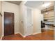 A modern foyer features wood flooring, a front door and a home office with desk and shelves in the background at 855 Peachtree Ne St # 1911, Atlanta, GA 30308