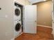 A stacked white washer and dryer units sit in an alcove with a white bi-fold closet door at 855 Peachtree Ne St # 1911, Atlanta, GA 30308