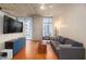 Modern living room with concrete ceiling, hardwood floors, large windows, and comfortable seating at 855 Peachtree Ne St # 1911, Atlanta, GA 30308