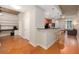 Open-concept living space with hardwood floors, kitchen bar, built-in shelving, and exposed concrete accents at 855 Peachtree Ne St # 1911, Atlanta, GA 30308