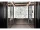 Modern elevator interior features mirrored walls, tile flooring, and updated fixtures at 923 Peachtree Ne St # 1527, Atlanta, GA 30309