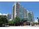 A wide angle shot of a high rise building with balconies and glass windows on a sunny day at 923 Peachtree Ne St # 1527, Atlanta, GA 30309