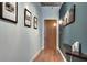 Hallway with hardwood floors, decorative wall art, and neutral paint at 923 Peachtree Ne St # 1527, Atlanta, GA 30309