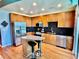 Bright kitchen featuring wood cabinets, stainless appliances, granite counters, and a breakfast bar at 923 Peachtree Ne St # 1527, Atlanta, GA 30309