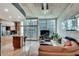 Living room and kitchen area showcasing concrete ceilings, hardwood floors, and glass balcony doors at 923 Peachtree Ne St # 1527, Atlanta, GA 30309