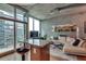 Bright living room with large windows, modern decor, and concrete accent wall at 923 Peachtree Ne St # 1527, Atlanta, GA 30309
