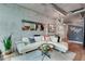 Cozy living room featuring a leather sofa, gray accent walls, and hardwood floors at 923 Peachtree Ne St # 1527, Atlanta, GA 30309