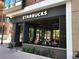 Inviting storefront of a Starbucks coffee shop with outdoor seating and large windows at 923 Peachtree Ne St # 1527, Atlanta, GA 30309