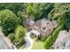 Aerial view of a stately home with manicured lawns and mature trees surrounding the property at 200 Rivermere Way, Sandy Springs, GA 30350