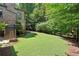 Expansive backyard with lush lawn and mature trees, creating a serene outdoor oasis at 200 Rivermere Way, Sandy Springs, GA 30350