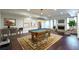 Finished basement with pool table, seating area, fireplace and hardwood floors at 200 Rivermere Way, Sandy Springs, GA 30350