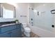 Bathroom features a gray vanity with black fixtures, a modern toilet, and a glass enclosed shower/tub combo at 200 Rivermere Way, Sandy Springs, GA 30350