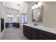 A spacious bathroom with double vanities, large tile floors, and an elegant chandelier at 200 Rivermere Way, Sandy Springs, GA 30350