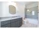 Modern bathroom features a gray vanity with a stone countertop and a glass-enclosed shower at 200 Rivermere Way, Sandy Springs, GA 30350