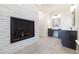 A cozy bathroom with a fireplace, double vanity, and brick accent wall at 200 Rivermere Way, Sandy Springs, GA 30350